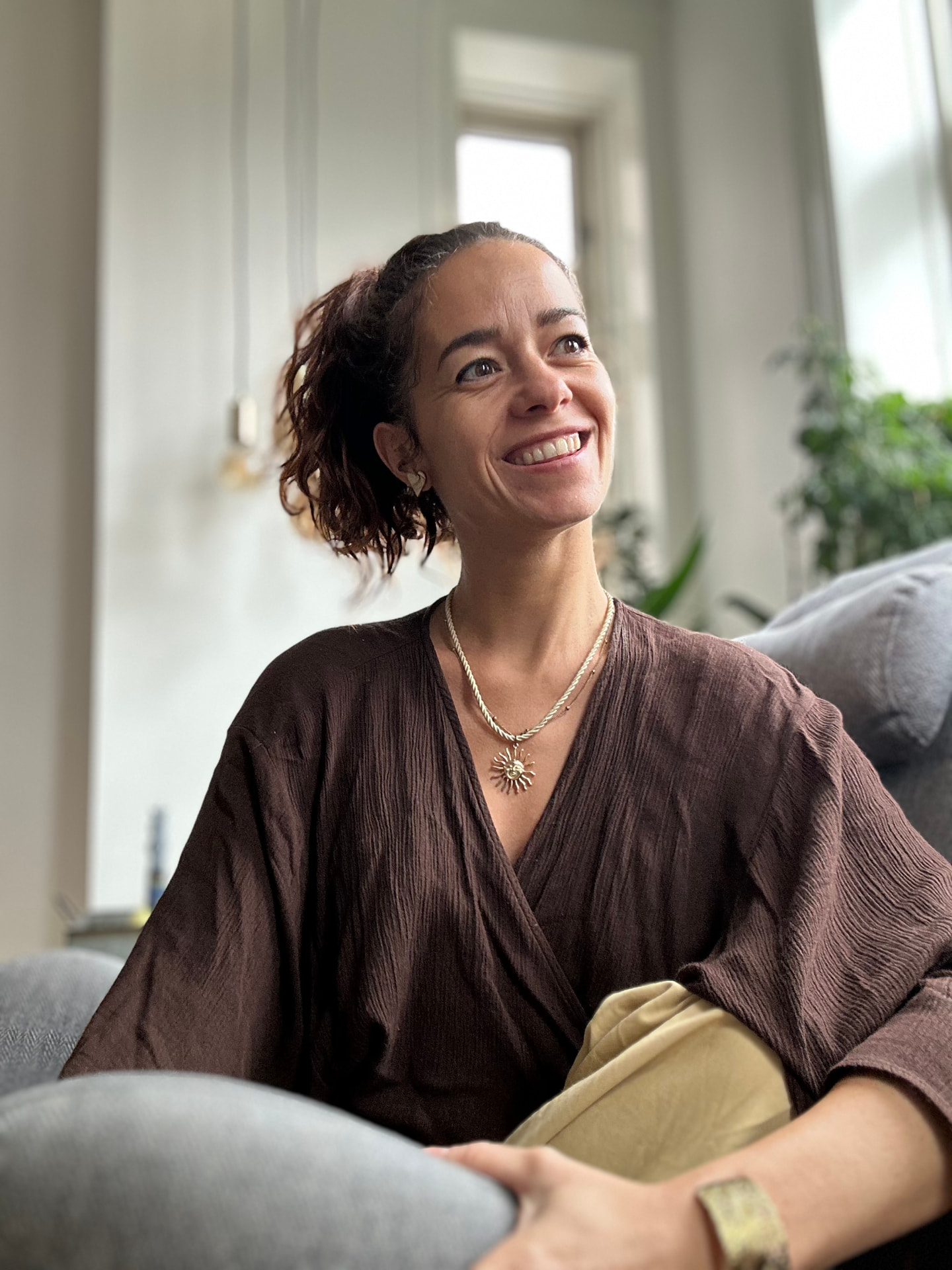 Audrey, leadership coach, smiling warmly in a brown top
